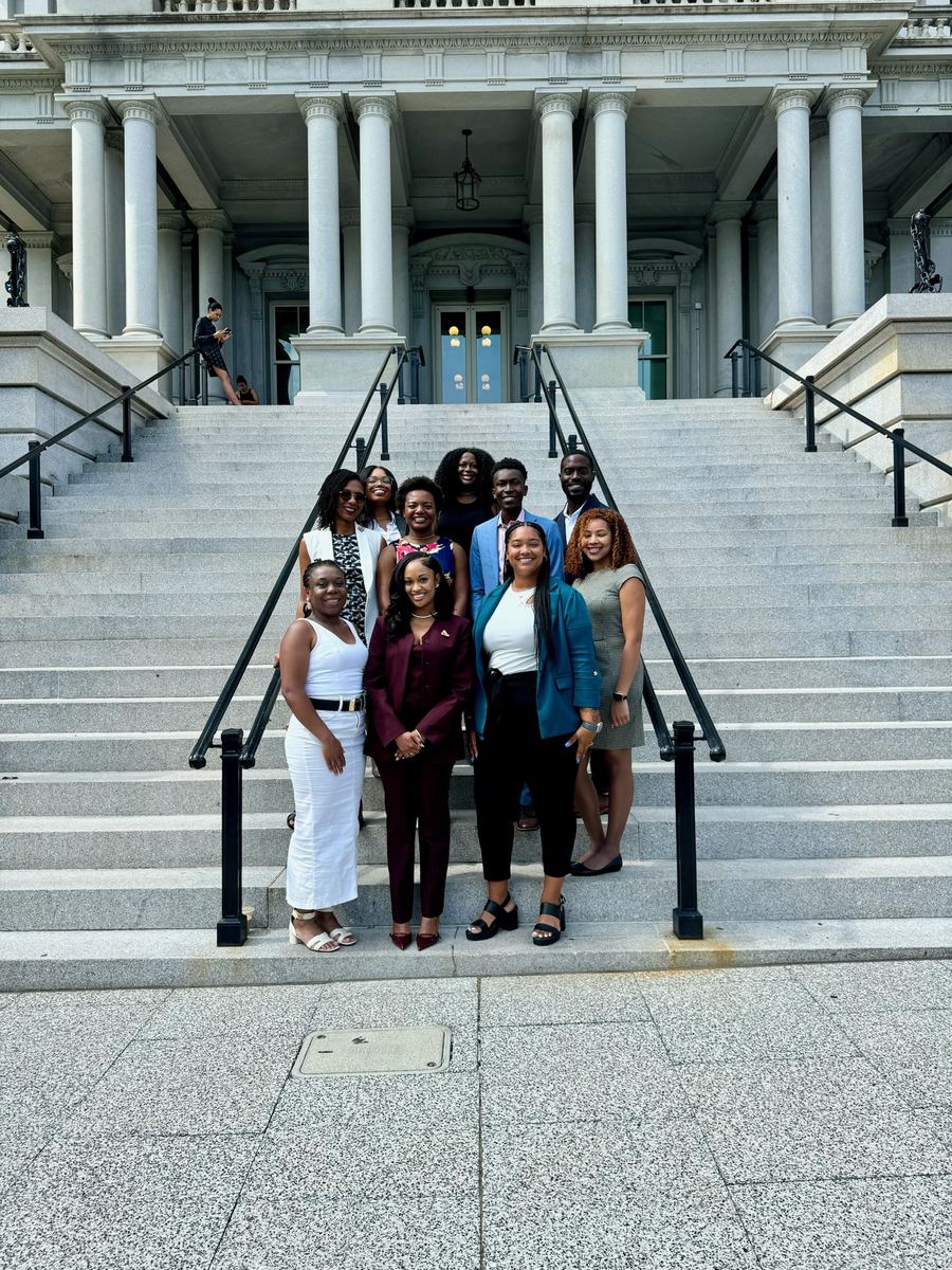 Collective members gathered on the navy steps of the Eisenhower Executive Office Building.