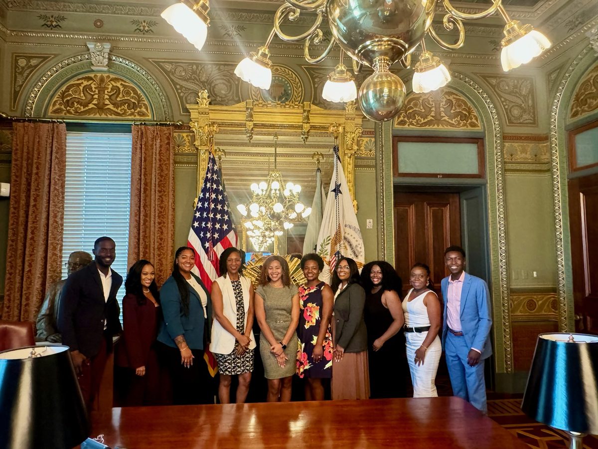 Collective members standing with National Space Council staff beneath the chandeliers of the Vice President's Ceremonial Office.